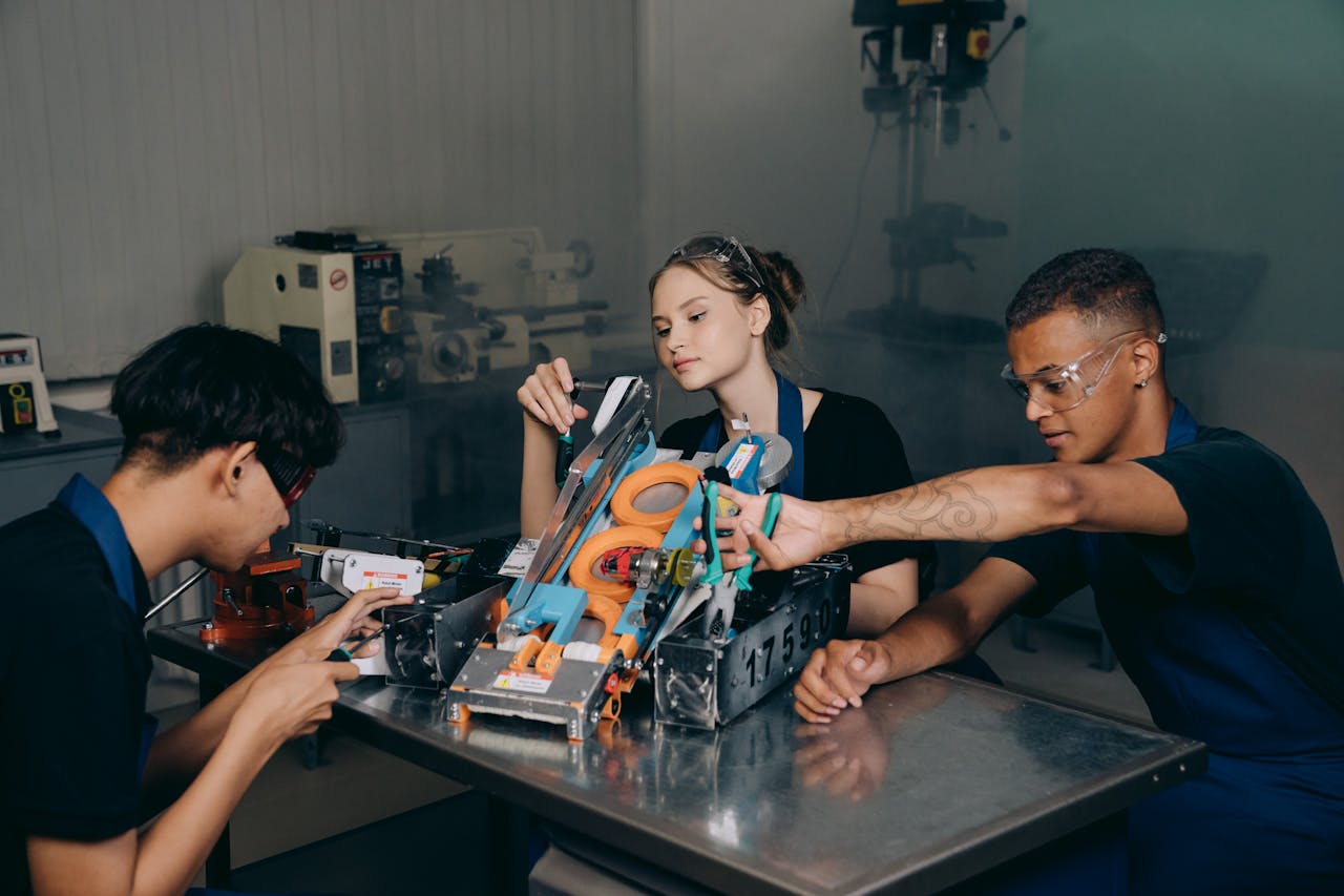 menu-05 Students engaged in assembling a robotics project in an educational lab setting.