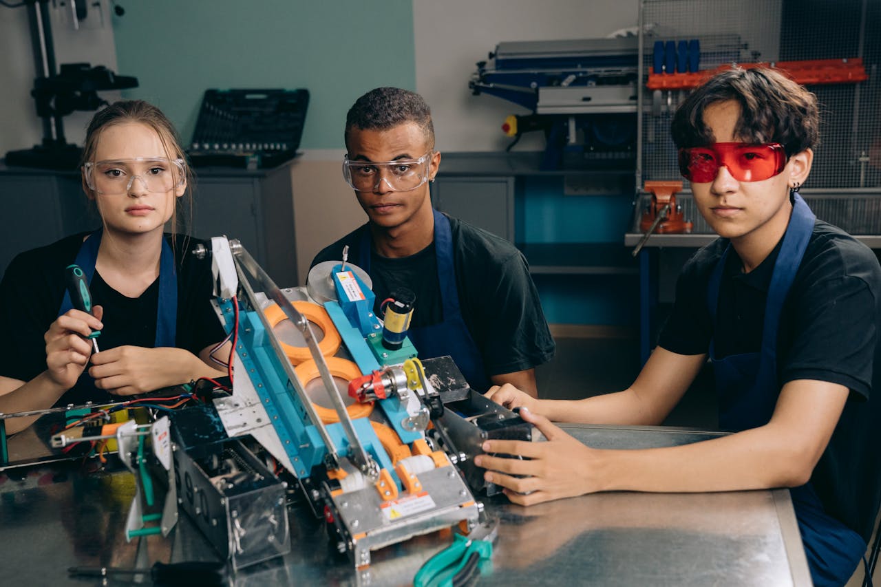 menu-15 Teenagers work on a robotics project, showcasing teamwork and technical skills in a laboratory setting.